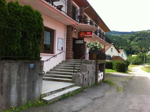 a building with stairs leading up to a door at Les Jolis Coeurs in Thiéfosse