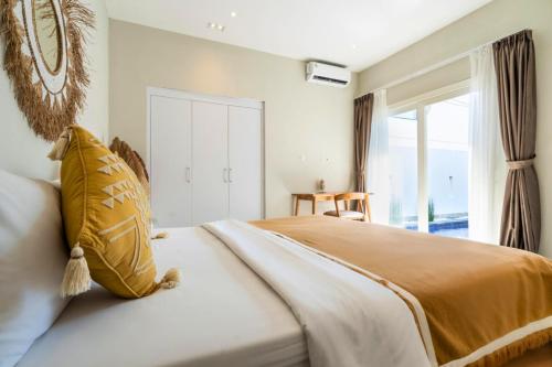a bedroom with a large bed and a window at Aquene 2 BR Private Pool Villa ZN277 in Pererenan