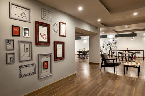 a room with a wall with pictures on it at Townhouse S R NAGAR in Ameerpet