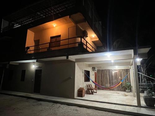 a view of a house at night with a balcony at Jericoacoara Suítes "Zona do Kite" in Jericoacoara
