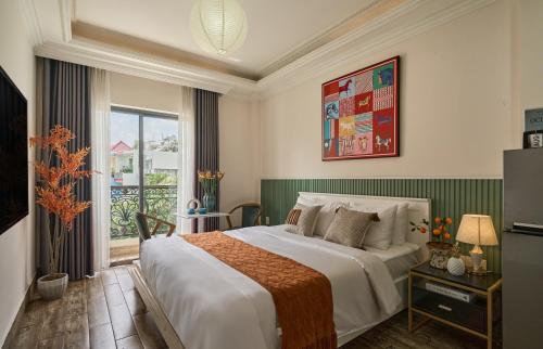 a hotel room with a bed and a balcony at The Passion Hotel Airport in Ho Chi Minh City