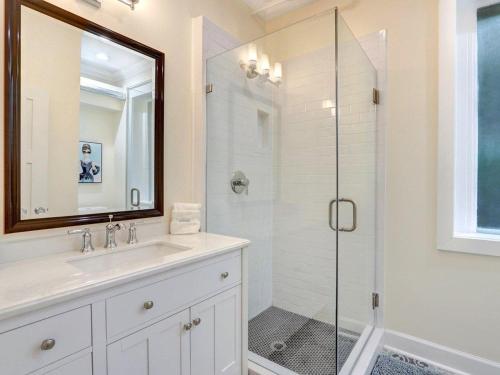 a bathroom with a sink and a glass shower at Liberty Street Retreat in Savannah
