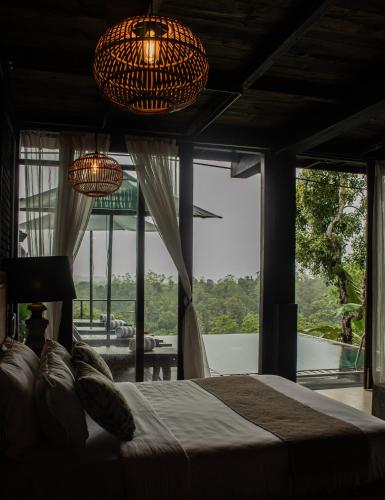 a bedroom with a bed and a large window at Villa Hillcrest Weligama in Weligama