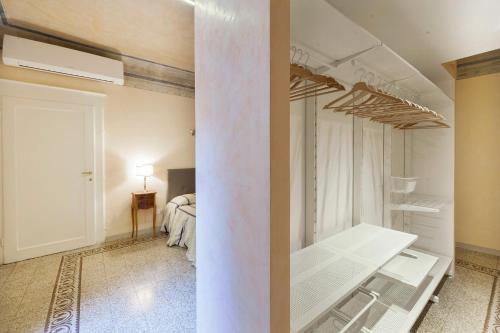 a white room with a bed in the background at 7Soli Charming Flat in Florence