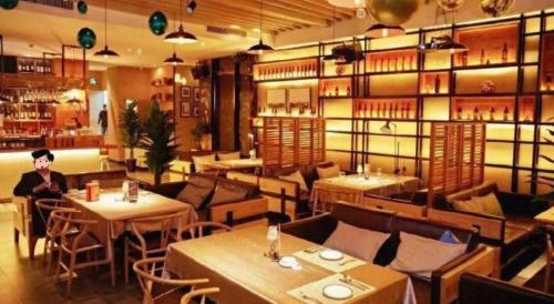 a man sitting at a table in a restaurant at City Comfort Inn Shantou Huashan Road the MixC in Shantou