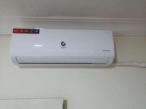 a white printer sitting on top of a wall at الرائد للشقق المفروشة in Amman