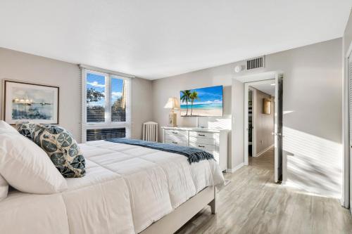 a bedroom with a large white bed and a desk at 889 Ketch Court in Hilton Head Island