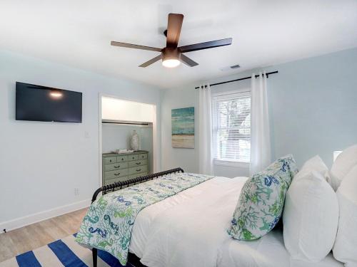a bedroom with a bed and a ceiling fan at Deja Blue B in Tybee Island