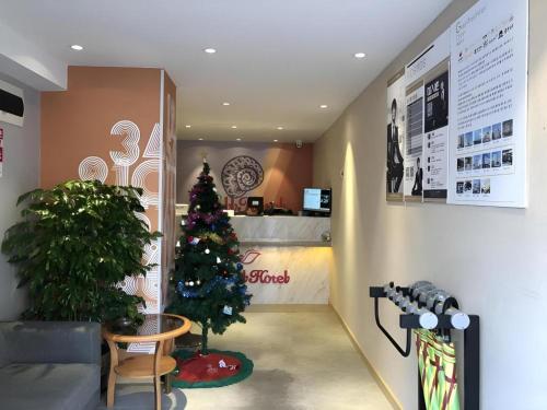 a christmas tree in the lobby of a store at Shell Hotel Shanghai Normal University Hongcao Road Metro Station Guiping Road in Shanghai