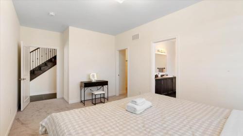 a white bedroom with a bed and a desk at Modern Bay Vista Getaways in Carrying Place