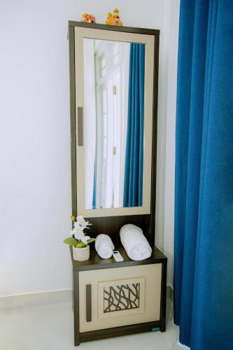 a mirror on a table with two pillows in a bathroom at Seya Villa in Kekirawa
