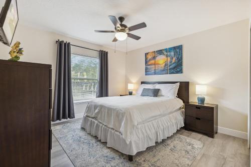 a bedroom with a bed and a ceiling fan at 601 Benedictine Ter in Sebastian
