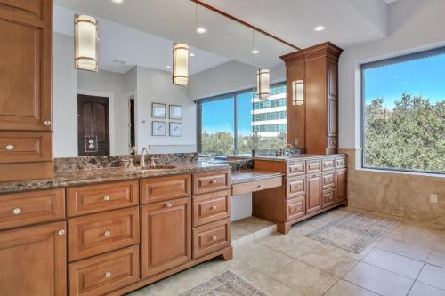 a large bathroom with two sinks and a large window at Sky Suite at 300 Drayton in Savannah
