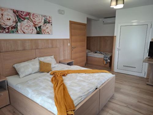 a bedroom with a bed with a blanket on it at Sobe Nobiles in Draganići