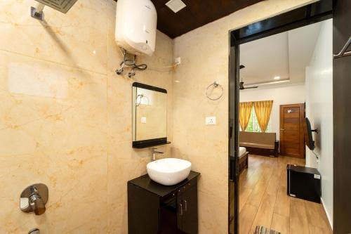 a bathroom with a sink and a mirror at Samba Castle by Starling in Gokarna