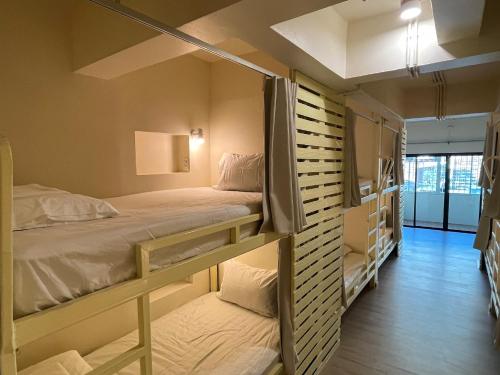 a room with two bunk beds and a hallway at Wonderful Life in Pattaya