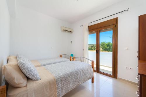 Ένα ή περισσότερα κρεβάτια σε δωμάτιο στο Ciel Blue Villas