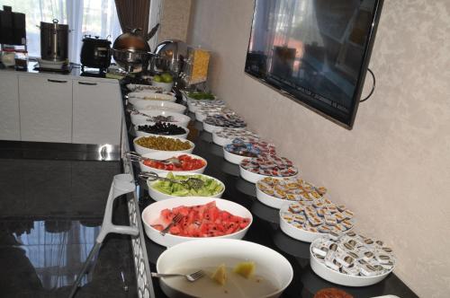 a long table with many plates of food on it at Grand Sera Hotel in Ankara