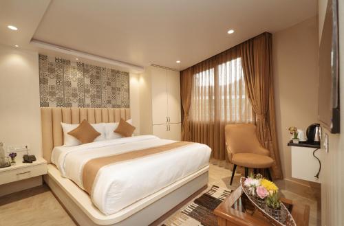 a bedroom with a large white bed and a window at PENANG Home Away From Home in Darjeeling