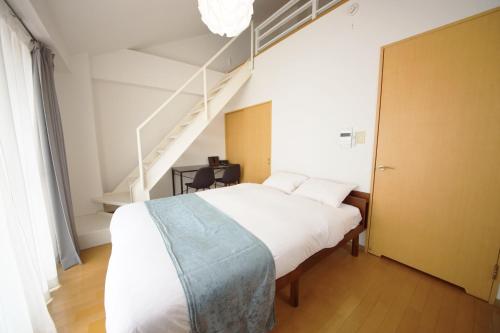 Giường trong phòng chung tại goom Hotel Nakasu BLUGE