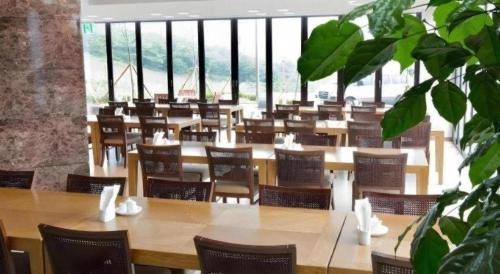 a row of tables and chairs in a room at Mungyeong saejae Resort in Mungyeong