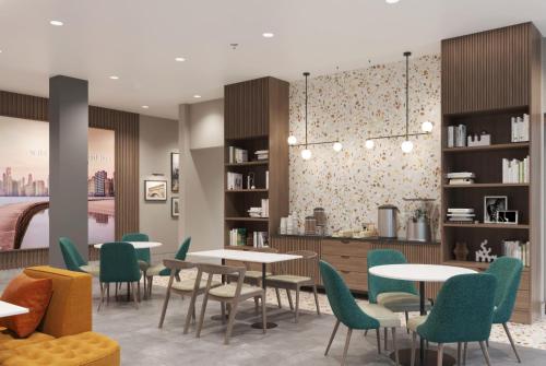 a rendering of a restaurant with tables and chairs at La Quinta Inn & Suites by Wyndham Tracy in Tracy