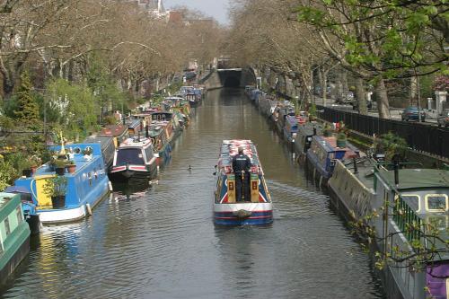 a group of boats are docked in a canal at The Colonnade in London