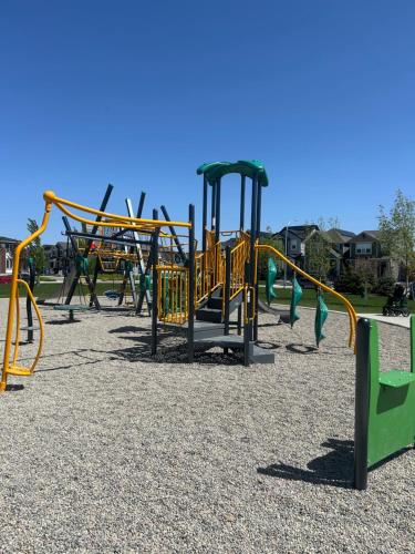 a playground with a bunch of playground equipment at Sunny Queen-size Bedroom with Private Bath in Brand New House in Calgary
