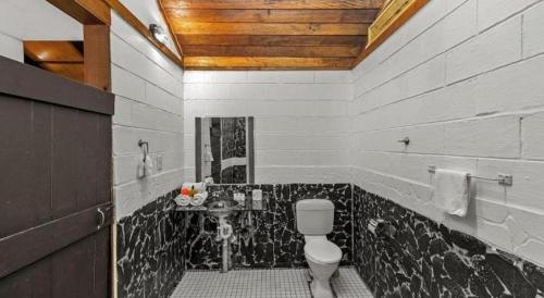 a bathroom with a toilet and a sink at Orator Hotel in Apia