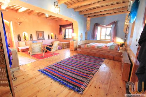 
a living room filled with furniture and pillows at La Perle Du Dades in Boumalne Dades
