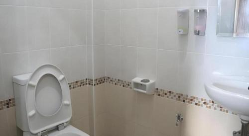 a bathroom with a toilet and a sink at N-Joy Place in Surin