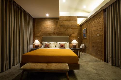a hotel room with a bed and two lamps at Seven Havens Residence in Selong Belanak
