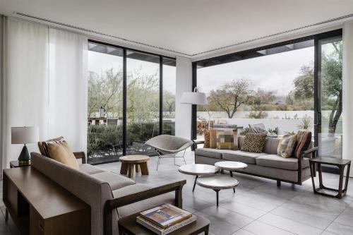 a living room filled with furniture and a large window at Andaz Scottsdale Resort & Bungalows in Scottsdale