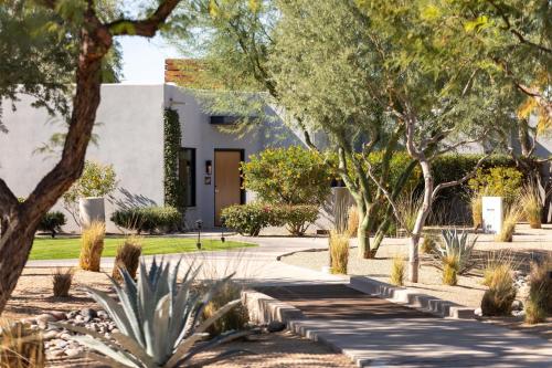 a garden with trees and a building at Andaz Scottsdale Resort & Bungalows in Scottsdale