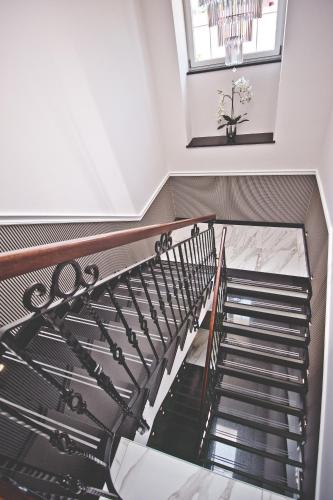 a spiral staircase in a building with a window at Hotel Toscania in Włoszakowice