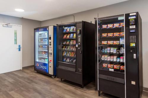 two soda vending machines in a room with drinks at MainStay Suites Denver Tech Center in Centennial