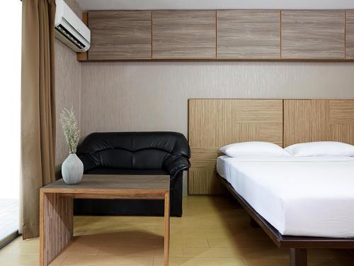 Postel nebo postele na pokoji v ubytování Watana Hotel
