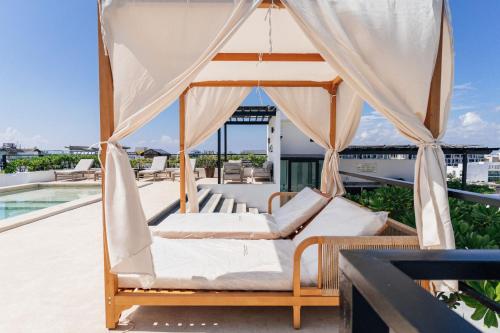 a swing bed on the roof of a house at Luxury Apartment top location! in Playa del Carmen