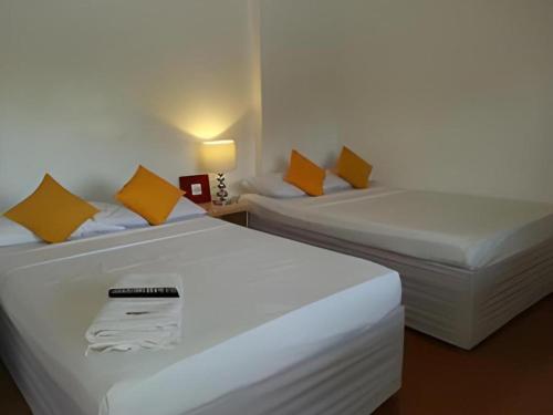 two beds sitting next to each other in a room at House of Big Brother in Puerto Princesa City