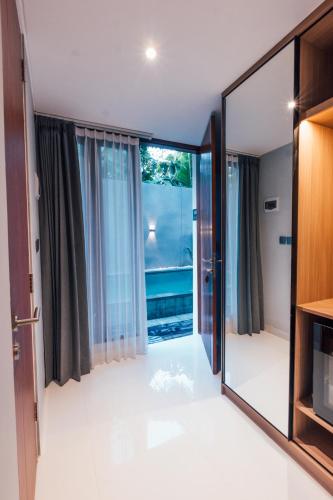 a large mirror in a room with a large window at Royal Sweet By Sika in Canggu