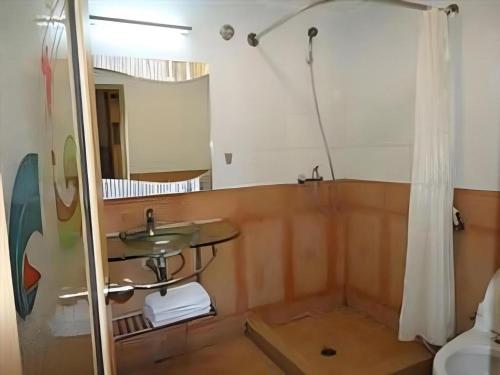 a bathroom with a sink and a mirror at Hotel Formosa in Manado