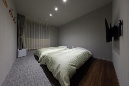 a bedroom with two beds in a room at Hotel Yatsu in Komatsu