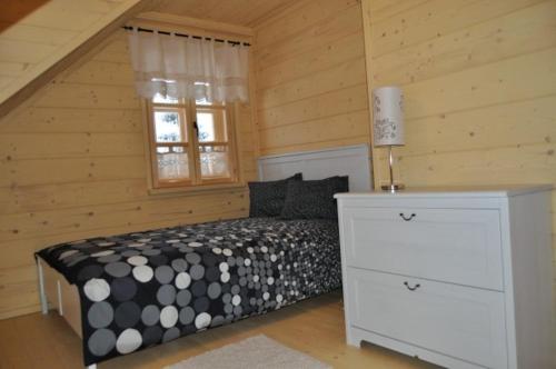 a bedroom with a bed and a window at Anielska Chata in Istebna