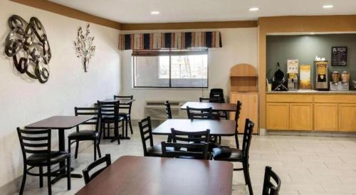 a dining room with tables and chairs in a restaurant at Quality Inn in Albuquerque