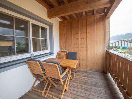 a porch with a table and chairs on a balcony at Apartment near the ski slope in Brixen in Feuring