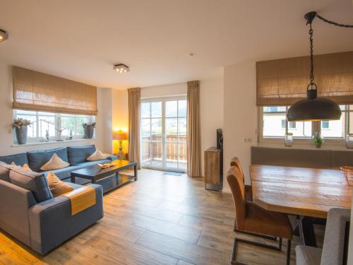 a living room with a couch and a table at Modern apartment near the ski area in Brixen im Thale