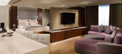 a hotel room with two beds and a tv at HS HOTSSON Hotel Silao in Silao