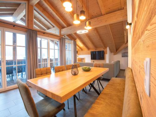 a dining room with a wooden table and chairs at Luxury penthouse with Balcony Ski Storage Carport Lift in Brixen im Thale