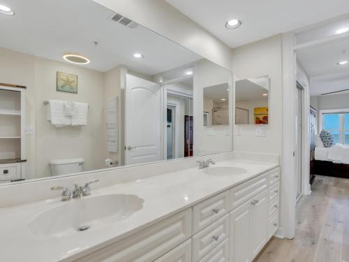 a bathroom with two sinks and a large mirror at Relax-Unwind-Enjoy in Tybee Island