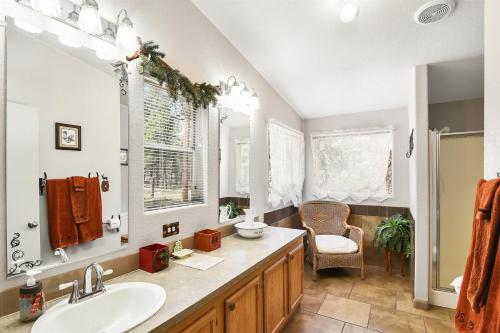 a bathroom with a sink and a mirror at Gorgeous Historic 3 BR Log Cabin w Forest Views 20 Minutes from Flagstaff Now with Wi-Fi in Parks